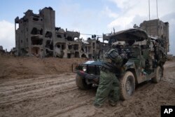 FILE - An Israeli soldier stands guard during the ground offensive on the Gaza Strip in Khan Younis, January 27, 2024.