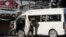 An Afghan security forces member inspects a bus carrying local TV station employees that hit a roadside bomb in Kabul, Afghanistan, Saturday, May 30, 2020. 