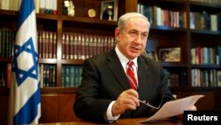 Israeli Prime Minister Benjamin Netanyahu gestures as he speaks, in Jerusalem, June 2013.