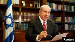 Israeli Prime Minister Benjamin Netanyahu gestures as he speaks, in Jerusalem, June 2013.