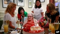 FILE - Clare Hollingworth, center, a British former longtime foreign correspondent, is surrounded by friends and admirers at her birthday party at Hong Kong's Foreign Correspondents' Club, Oct. 10, 2016.