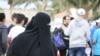 FILE - A woman wears a mandatory abaya, or loose-fitting gown, over her clothes in Jeddah, Saudi Arabia, Jan. 28. 2016. Rumors are circulating that a mixed-gender nightclub that does not require women to wear loose robes has opened in the city. (H. Murdock/VOA)