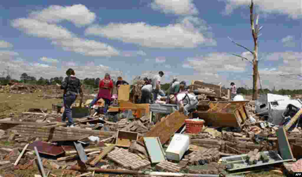 Residents search through what is left of their homes after a tornado hit Pleasant Grove just west of downtown Birmingham yesterday afternoon on Thursday, April 28, 2011, in Birmingham, Ala. President Barack Obama said he would visit Alabama Friday to vie