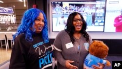 FILE - Detroit Lions fans Verdell Blackmon, left, and her daughter A.J. Brown are interviewed before a game between the Minnesota Vikings and Lions, Dec. 5, 2021, in Detroit.