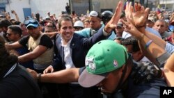 Venezuela's self-proclaimed president Juan Guaido greets supporters in Caracas, Venezuela, April 30, 2019.