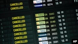 FILE - The pandemic has been tough on the travel industry. This May 12, 2020, photo of a departure timetable board displays canceled flights at Brussels Airport in Brussels, with disruptions due mainly to COVID-19.