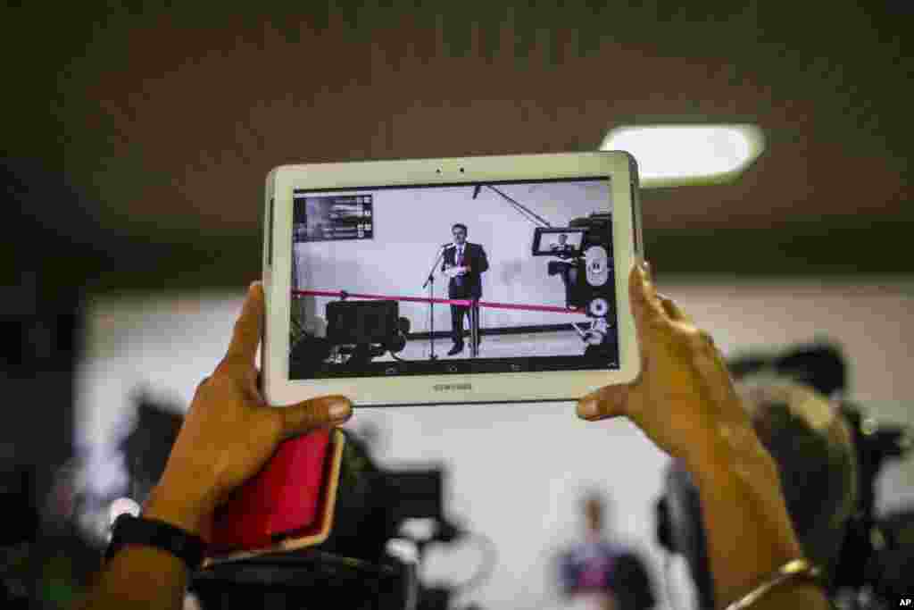 A journalist records a video of Gustavo Machin, Cuba&rsquo;s deputy chief of North American affairs, during the second day of talks between Cuban and U.S. officials, in Havana, Jan. 22, 2015.