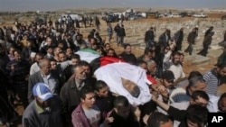 Mourners carry the body of Khairi Saad, 55, who died in the anti-government protests, at the Islamic cemetery in Sahab, near Amman, in Jordan, March 27, 2011