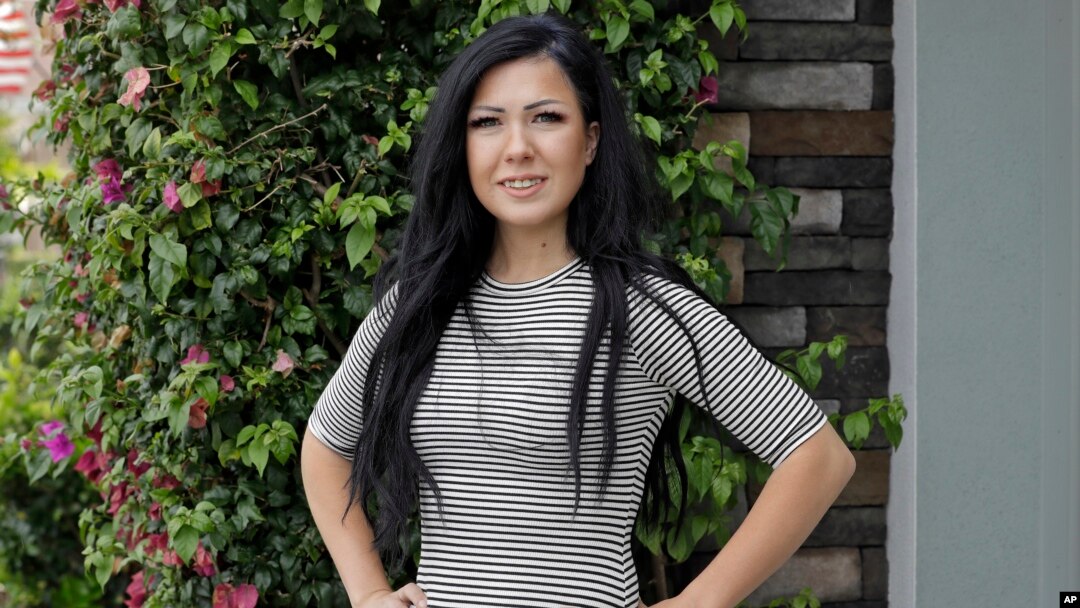 Lorin Lynch poses for a photo outside her home, June 8, 2020, in Wesley Chapel, Fla. When the tourists stopped coming in March, so did Lynch's paychecks from a Tampa Bay hotel.