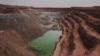 FILE - An open-air uranium mine is seen at a uranium mining facility in Arlit, Sept. 25, 2013. Niger and China have talked of deals that include a uranium mine, as well as an industrial park and an oil pipeline.