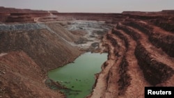 FILE - An open-air uranium mine is seen at a uranium mining facility in Arlit, Sept. 25, 2013. Niger and China have talked of deals that include a uranium mine, as well as an industrial park and an oil pipeline.