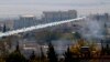 FILE - A rocket believed to have been launched by Islamic State forces flies from the east to the west side of the Syrian town of Kobani during fighting, Nov. 6, 2014 Picture taken from the Turkish side of the Turkey-Syria border. 