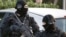 Policemen (GIPN) take part in a search in Coueron, western France as part of dawn raids in several French cities, March 30, 2012.