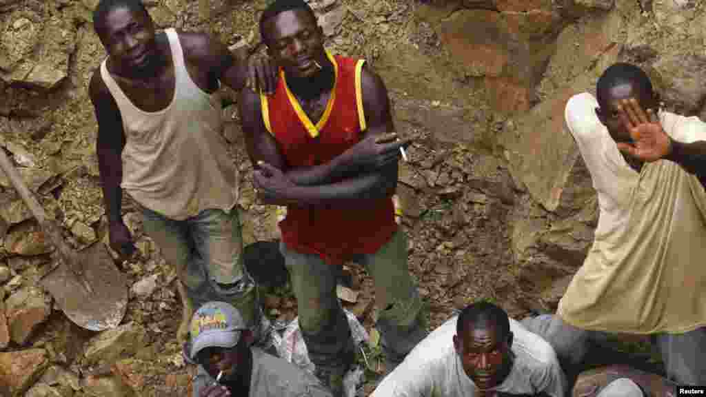Workers look up from one of the pits of a mine, believed to contain gold, in Minna, Niger State.