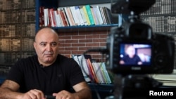 FILE—Tunisian prominent journalist Mohamed Boughalleb looks on as he prepares for the filming of his show to broadcast via YouTube, in Tunis, Tunisia September 30, 2022.