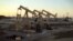 FILE - Oil rig pumpjacks, also known as thirsty birds, owned by Occidental Petroleum Corporation, operate near Long Beach, Calif., July 30, 2013.