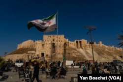 The flag of the new regime in Syria is displayed in Aleppo’s citadel, one of the most iconic sites in the ancient city, Dec. 15, 2024.