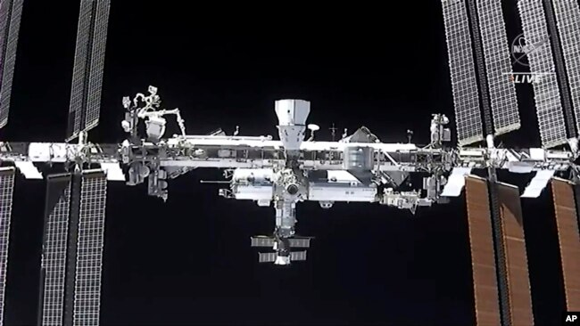 FILE - This image made from NASA TV shows the international space station, seen from the SpaceX Crew Dragon spacecraft, April 24, 2021. NASA earlier this week delayed a planned spacewalk due to menacing space junk.