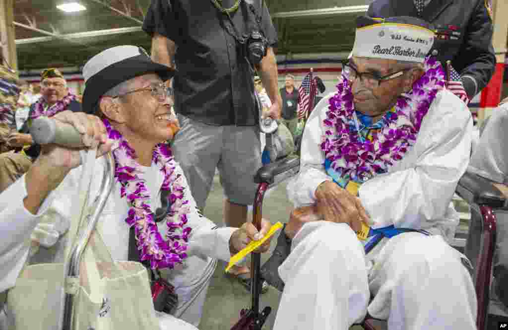 Kathleen Chavez, left, talks with her father Ray Chavez, right, age 104, of the USS Condor. The oldest living survivor from the Pearl Harbor attacks along with the remaining living survivors of the USS Arizona gathered at the World War II Valor in the Pacific National Monument at Joint Base Pearl Harbor-Hickam, in Honolulu, Hawaii.