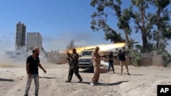 In this July 26, 2014 frame grab from video obtained from a freelance journalist traveling with the Misrata brigade, Islamist Misrata brigade fighters fire towards Tripoli airport in an attempt to wrest control from a powerful rival militia, in Tripoli, Libya.