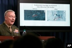 Marine Lt. Gen. Kenneth F. McKenzie Jr., director, Joint Staff, speaks as he shows photographs from before and after the U.S.-led airstrikes against Syria during a media availability at the Pentagon, April 14, 2018, in Washington.