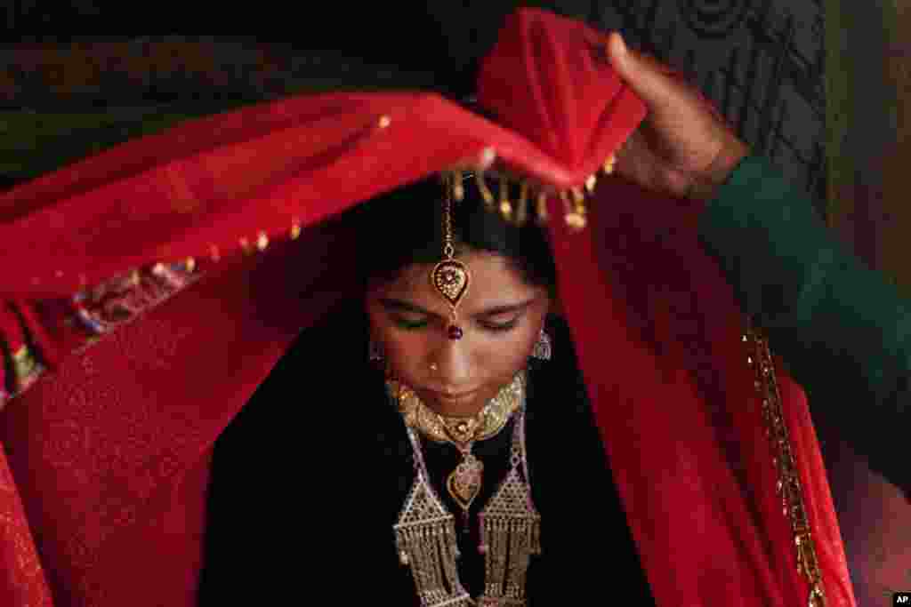 Zareena, a Kashmiri Bakarwal bride is seen inside her tent during her wedding ceremony on the outskirts of Srinagar, India. Bakarwals are nomadic herders in Jammu Kashmir state, who wander in search of good pastures for their cattle.