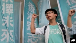 FILE - Joshua Wong shouts slogans outside a magistrate's court in Hong Kong. Wong was travelling to Bangkok to speak about his campaign for democracy at a city college, according to a post on the Facebook page belonging to his political party, Demosisto.