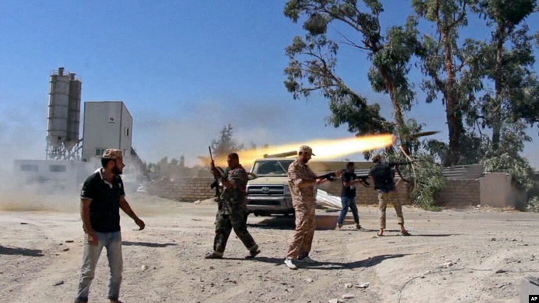 In this July 26, 2014 frame grab from video obtained from a freelance journalist traveling with the Misrata brigade, Islamist Misrata brigade fighters fire towards Tripoli airport in an attempt to wrest control from a powerful rival militia, in Tripoli, Libya.