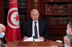 FILE - Tunisia's President Kais Saied presides at a security meeting with members of the army and police forces in Tunis, July 25, 2021.