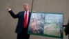 FILE - President Donald Trump talks with reporters as he gets a briefing on border wall prototypes, in San Diego, California March 13, 2018.