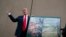FILE - President Donald Trump talks with reporters as he gets a briefing on border wall prototypes, in San Diego, California March 13, 2018.