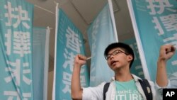 FILE - Teen protest leader Joshua Wong shouts slogans outside a magistrate's court in Hong Kong.