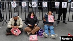 Activists hold a protest against a law that militarizes crime fighting in the country outside the Senate in Mexico City, Mexico, Dec. 14, 2017.