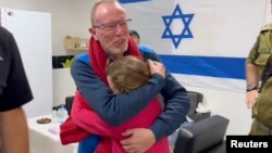 FILE—Irish-Israeli girl Emily Hand meets her father Thomas Hand after being released as part of a hostages-prisoners swap deal between Hamas and Israel amid a temporary truce, at an unknown location in Israel, in this screengrab from a handout video released November 26, 2023.