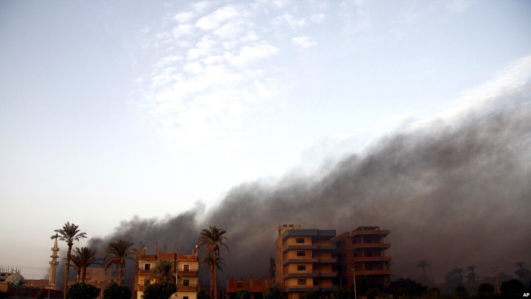 Smoke rises during clashes between Egyptian security forces and suspected militants, not pictured, in the town of Kirdasah, near Giza Pyramids, Egypt, Sept. 19, 2013.