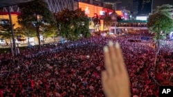 A pro-democracy protester flashes a three-finger salute, a symbol of resistance, during an anti-government rally in the central business district of Bangkok, Thailand, Oct. 15, 2020. 