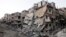 A general view shows damaged buildings on a deserted street in the besieged area of Homs, Syria, July 12, 2013. 