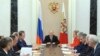 Russian President Vladimir Putin (C) chairs a meeting with members of the Security Council at the Kremlin in Moscow, Mar. 6, 2015. Russia is seen as using propaganda and money to, as one analyst put it, "divide and split Europe." 