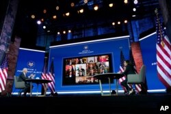 FILE - President-elect Joe Biden and Vice President-elect Kamala Harris participate in a meeting with state officials, at The Queen Theater, Nov. 19, 2020, in Wilmington, Delaware.