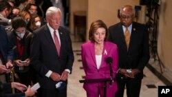 House Speaker Nancy Pelosi, center, with Majority Leader Steny Hoyer, left, and Majority Whip James Clyburn updates reporters after delays in the vote to advance President Joe Biden's domestic policy package, at the Capitol in Washington, Nov. 5, 2021.