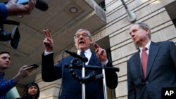 Attorney Paul Kamenar, left, speaks to the media after presenting arguments in federal court about special counsel Robert Mueller's appointment to lead the Russia investigation, in Washington, Nov. 8, 2018. 