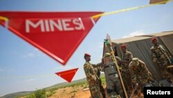 A former pro-government militia member is helped into a de-mining suit in Belet Weyne, Somalia, in this Nov. 17, 2012 handout photo by African Union-United Nations Information Support Team (AU-UN IST). 