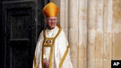 FILE - Archbishop of Canterbury Justin Welby stands at Westminster Abbey ahead of the coronation of King Charles III and Camilla, the Queen Consort, in London, May 6, 2023.