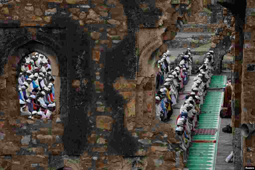 Muslims offer Eid al-Adha prayers at the ruins of Feroz Shah Kotla mosque in New Delhi, India.