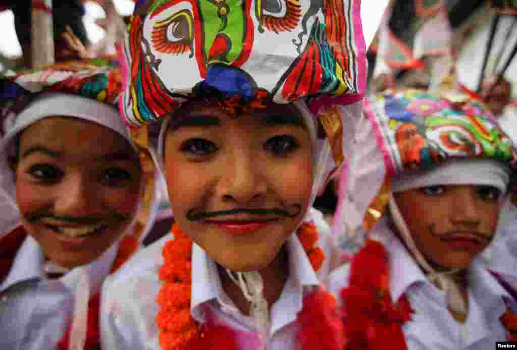 Boys dressed in white depicting holy cows participate in a parade to mark Gaijatra Festival, also known as the festival of cows, in Kathmandu, Nepal.