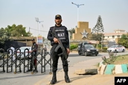 A Pakistani police commando stands guard outside the National Stadium in Karachi on Feb. 17, 2025. The International Cricket Council Champions Trophy begins on Feb. 19.