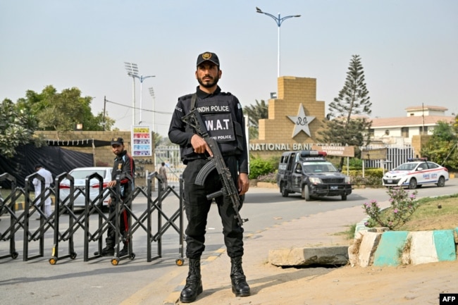 A Pakistani police commando stands guard outside the National Stadium in Karachi on Feb. 17, 2025. The International Cricket Council Champions Trophy begins on Feb. 19.