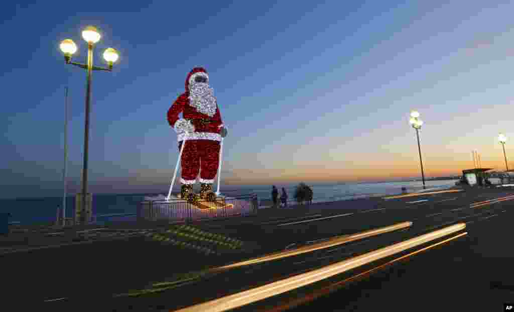 A giant illuminated Santa Claus is displayed on the Promenade des Anglais in Nice, southeastern France.