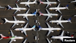 FILE - Grounded Boeing 737 Max aircraft are parked at Boeing Field in Seattle, Washington, July 1, 2019. 