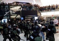 Riot police try to disperse protesters inside a mall in Sha Tin District in Hong Kong, July 14, 2019.